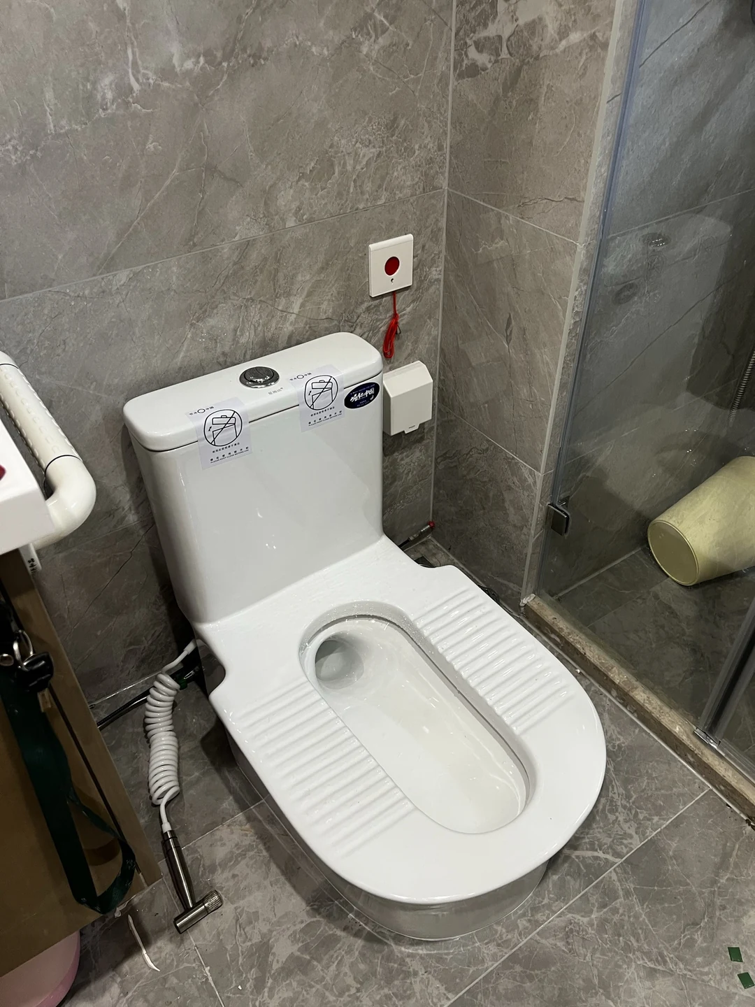 灰墙淋浴空间内安装完成的台式蹲便器,仅供空间布局参考